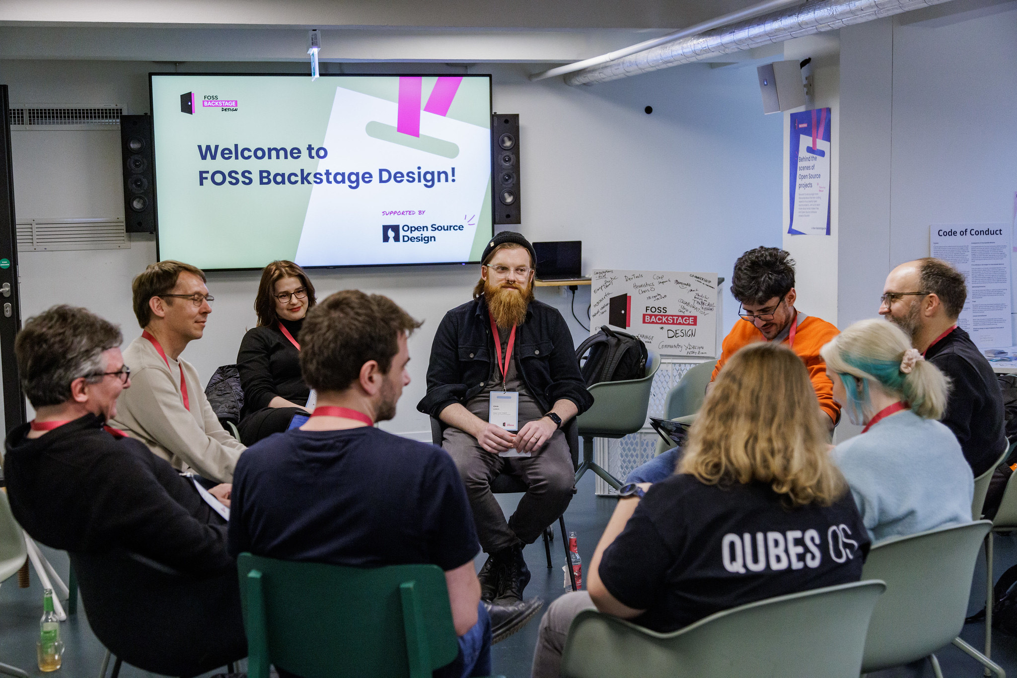 A circle of people discussing open source design topics at the barcamp