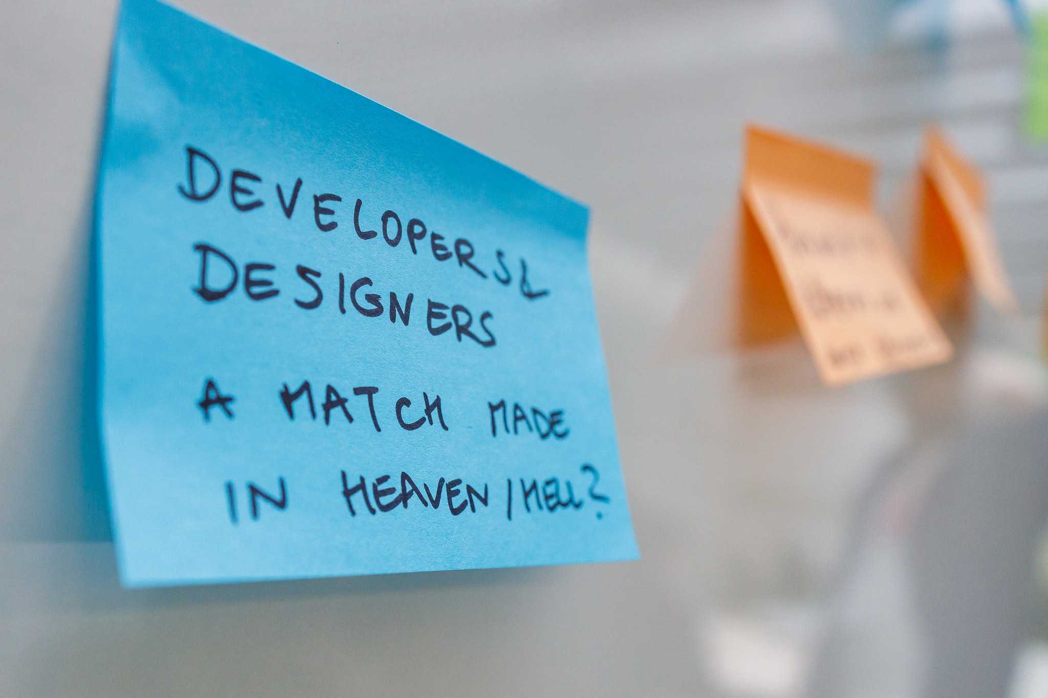 A sticky note that reads &lsquo;developers and designers, a match made in heaven/hell?